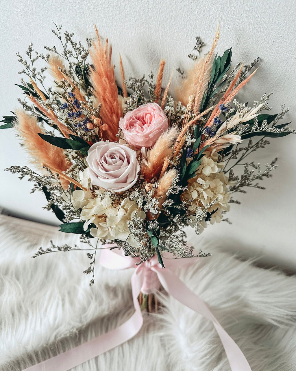Bouquet of flowers with pink and white roses on a white surface